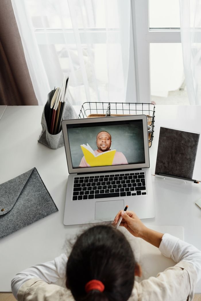 Hello world! Child participating in an online class with a teacher, using a laptop at home, ideal for educational technology themes.